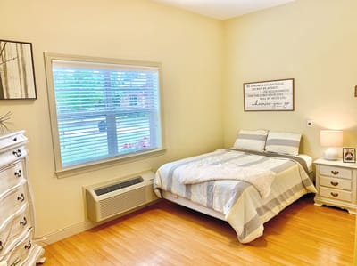 A cozy private resident room with a bed and window