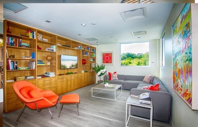 A cozy common area with bookshelves and seating