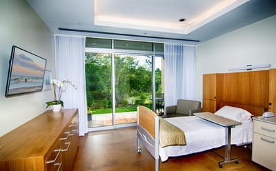Bright, modern patient room with access to outdoor area