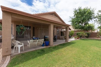 Outdoor patio area with seating and greenery