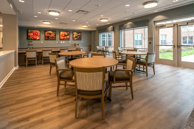 Bright common area with wooden tables and chairs