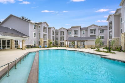An outdoor pool area surrounded by the building
