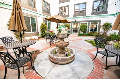 Outdoor seating area with a fountain and umbrellas