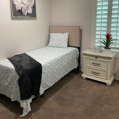 A cozy bedroom with a single bed and nightstand