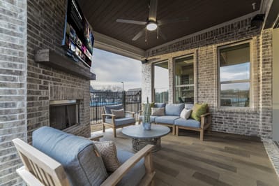 Outdoor seating area with comfortable furniture and TV