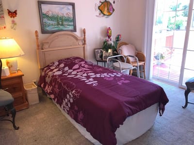 Cozy private bedroom with floral bedspread
