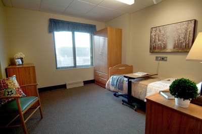 Cozy resident room with a bed and furniture