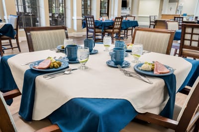 Dining table set with plates and drinks in an activity room