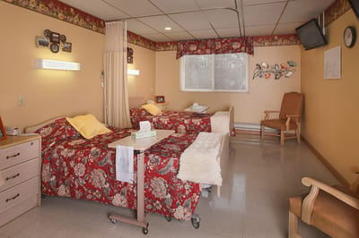 A cozy resident room with floral bedding and decor.
