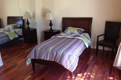 Cozy bedroom with a single bed and a lamp
