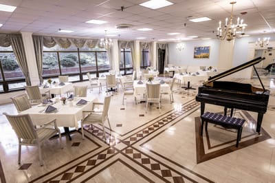 Elegant dining room setup with golden chandeliers