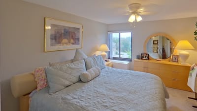 Cozy bedroom with a bed, lamps, and a window