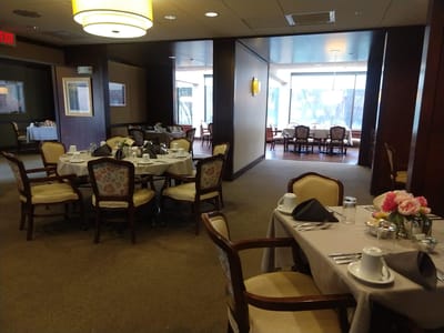 Dining room set up for a meal with floral centerpieces