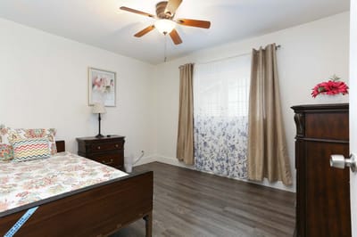Bright, well-decorated resident room with floral accents