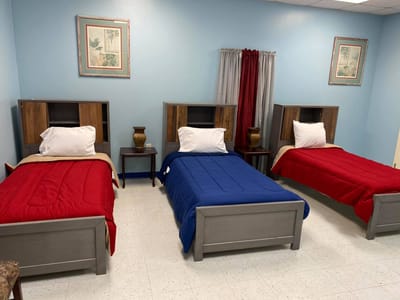 Two twin beds in a brightly colored resident room