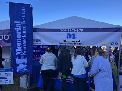 People at a sponsorship booth for an Alzheimer's event