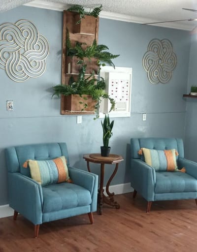 Interior seating area with decorative plants and chairs