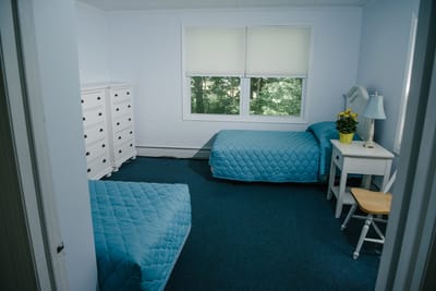 Simple resident room with two beds and a window