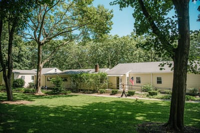 Exterior view of Olsen Rest Home with garden