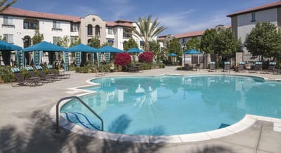 Swimming pool area with lounge chairs and umbrellas