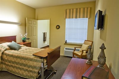 Cozy private resident room with a bed and chair