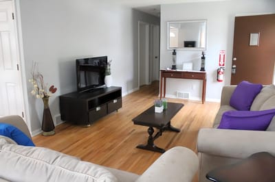 Bright common area with seating and TV