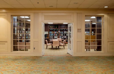 Interior view of a library with tables and bookshelves