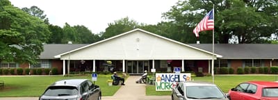 Exterior view of nursing home building with flag