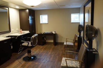 Hair salon area with styling stations and seating
