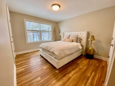 Well-furnished private bedroom with natural light