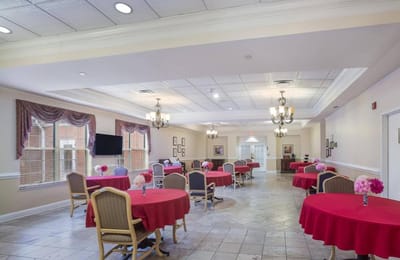 Bright dining room with round tables and floral centerpieces