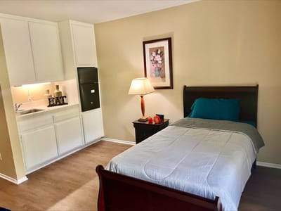 Cozy resident room with bed and kitchenette