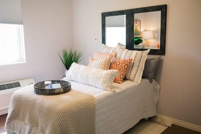 Cozy resident room with decorative pillows and a plant
