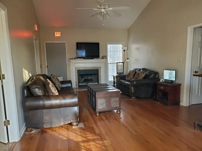 Cozy common area with two sofas and a fireplace