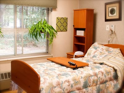 A cozy resident room with bed and window