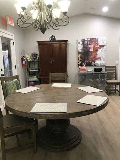 Interior dining room with a round table and chandelier