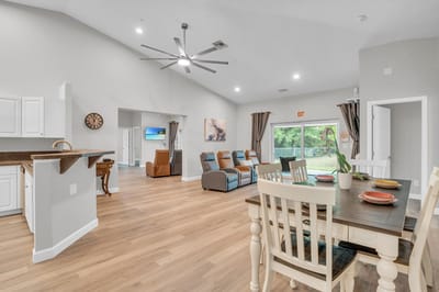 Bright interior common area with dining table and seating