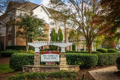 Exterior view of The Gables at Druid Hills sign and building