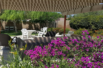 Shaded outdoor seating area with flowers