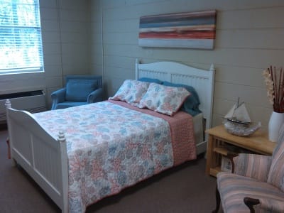 Cozy resident room with bed and chairs