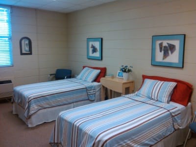 Private resident room with two beds and artwork