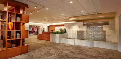 Interior view of a calming common area with a water feature