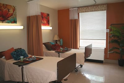 A shared resident room with two beds and decor