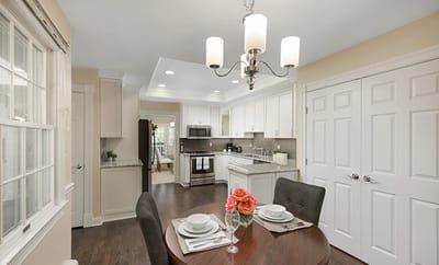 Bright kitchen area with dining table and flowers