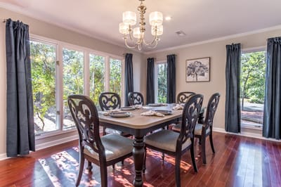Bright dining area with a large table and windows