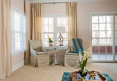 Brightly lit interior corner with two chairs and a table