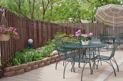 A peaceful outdoor seating area with flowers