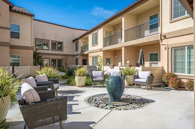 Outdoor courtyard with comfortable seating and a fountain