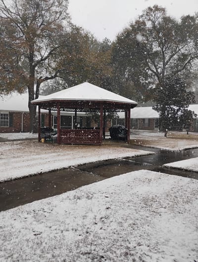 Gazebo covered in snow in a senior living facility
