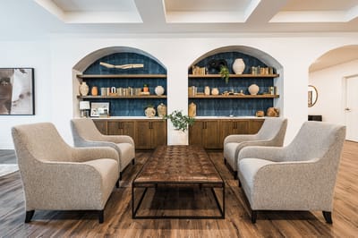 Bright common area with comfortable seating and decorative shelves